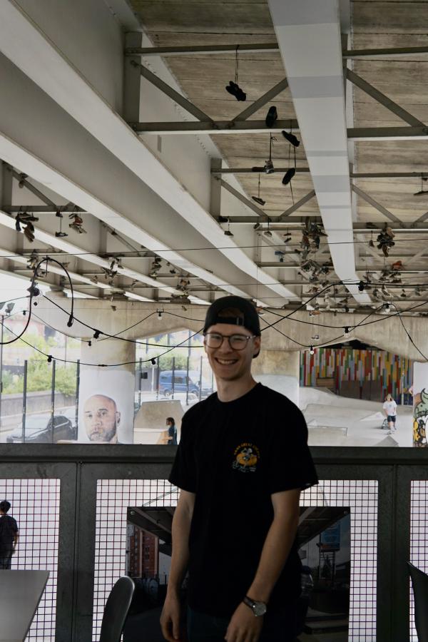 Me on the gantry smiling with the skatepark behind me.